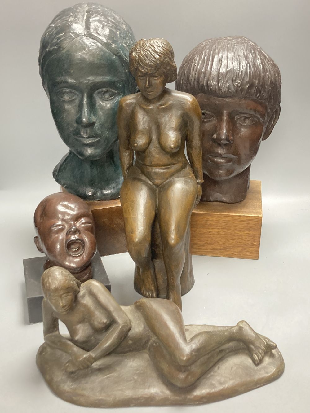Five bronzed plaster and resin figures / busts, seated lady 39cm